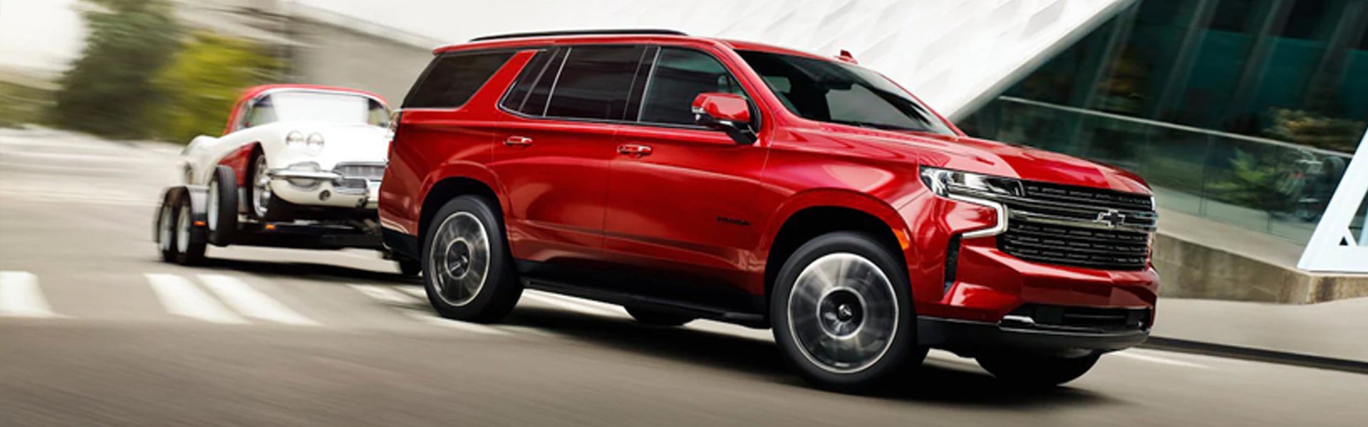 A 2020 Chevrolet Suburban towing a car