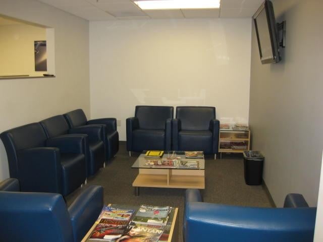 Waiting area with chairs and a TV